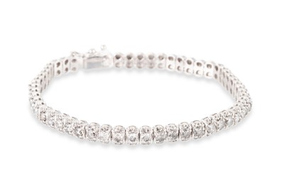 Lot 152 - A DIAMOND CLUSTER BRACELET, set with brilliant...