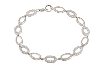 Lot 67 - A WHITE GOLD GEM-SET BRACELET, of oval linked...
