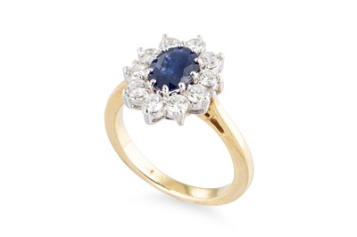 Lot 323 - A SAPPHIRE AND DIAMOND OVAL CLUSTER RING,...