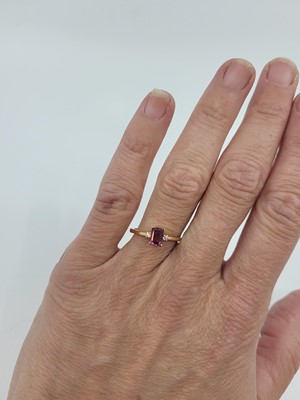 Lot 150 - A GARNET AND DIAMOND SET RING, mounted in 18ct...