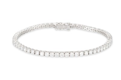 Lot 182 - A DIAMOND LINE BRACELET, the round brilliant...