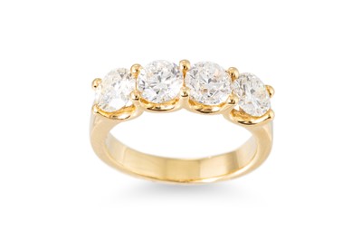 Lot 201 - A DIAMOND FOUR STONE RING, the four round...