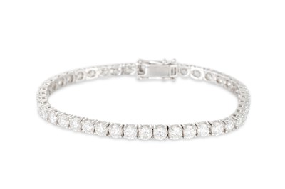Lot 326 - A DIAMOND LINE BRACELET, the brilliant cut...