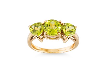 Lot 266 - A THREE STONE PERIDOT SET RING, mounted in 9ct...