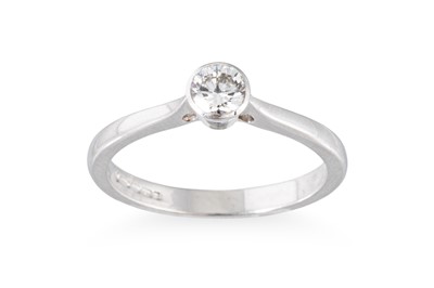 Lot 99 - A DIAMOND SOLITAIRE RING, the bezel set round...