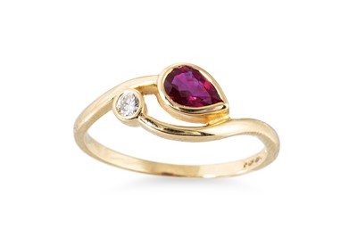 Lot 100 - A RUBY AND DIAMOND SET CROSS OVER STYLE RING,...