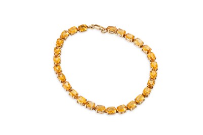 Lot 25 - A CITRINE SET LINE BRACELET, the oval citrines...