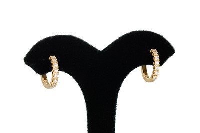 Lot 309 - A PAIR OF DIAMOND HOOP EARRINGS, huggie style,...