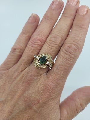 Lot 71 - AN EMERALD AND DIAMOND CLUSTER RING, the...