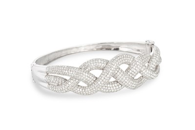 Lot 238 - A DIAMOND BANGLE, mounted in white gold...