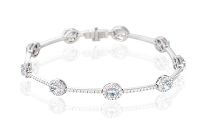 Lot 328 - AN AQUAMARINE AND DIAMOND SET CLUSTER BRACELET,...