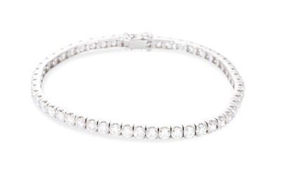 Lot 331 - A DIAMOND LINE BRACELET, the brilliant cut...