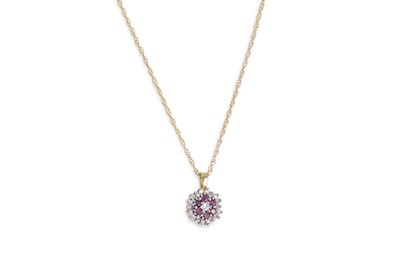 Lot 24 - A RUBY AND DIAMOND CLUSTER PENDANT, the...