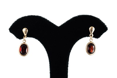 Lot 80 - A PAIR OF GARNET DROP EARRINGS, the oval cut...