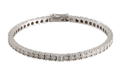 Lot 56 - A DIAMOND SET HINGED BRACELET, the circular...
