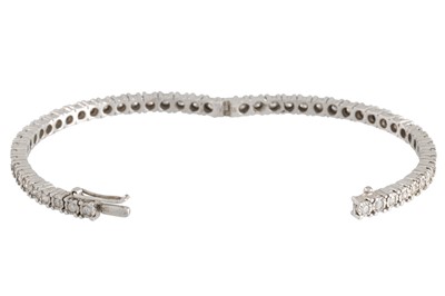 Lot 56 - A DIAMOND SET HINGED BRACELET, the circular...