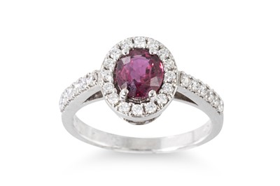 Lot 141 - A RUBY AND DIAMOND CLUSTER RING, the oval ruby...