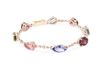 Lot 253 - A MULTI-GEM SET BRACELET, the various cut...