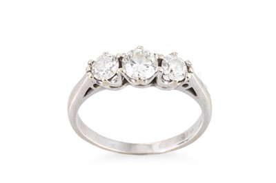 Lot 128 - A THREE-STONE DIAMOND RING, the brilliant cut...
