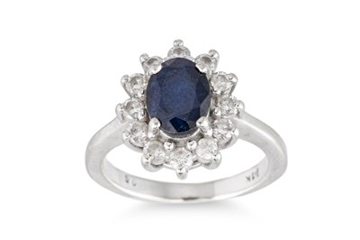 Lot 238 - A SAPPHIRE AND DIAMOND CLUSTER RING, mounted...