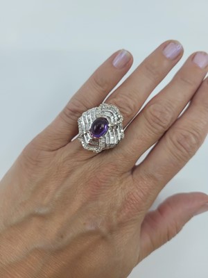 Lot 10 - A DIAMOND AND STONESET CLUSTER RING, the round...