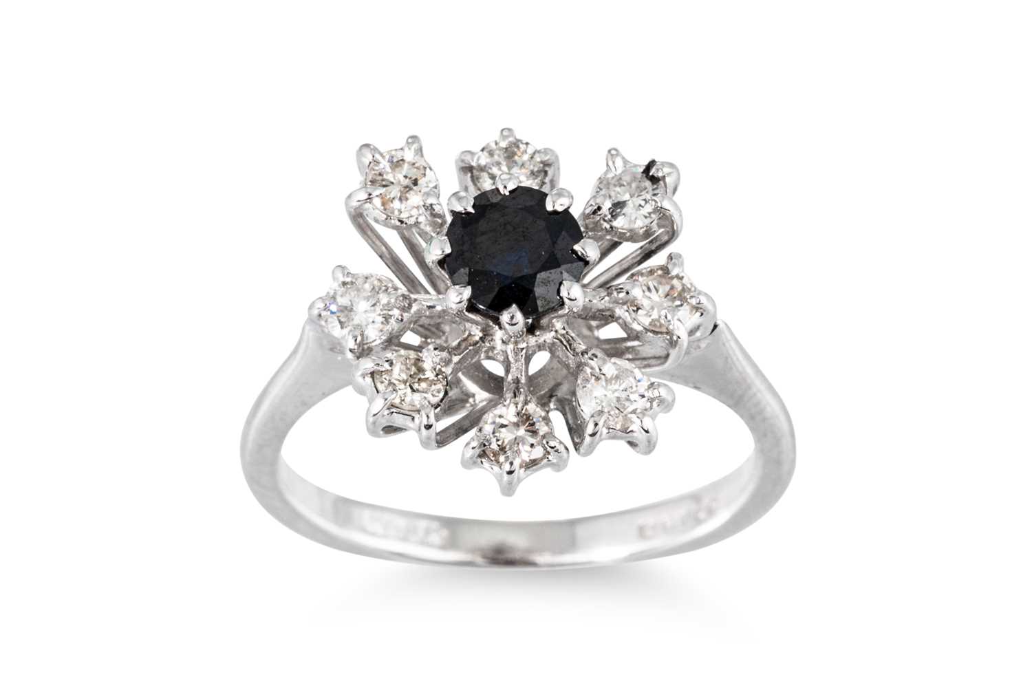 Lot 23 - A DIAMOND AND SAPPHIRE CLUSTER RING, the...