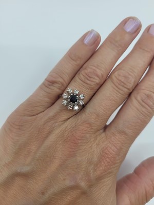 Lot 23 - A DIAMOND AND SAPPHIRE CLUSTER RING, the...