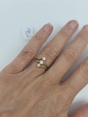Lot 81 - A 9CT GOLD THREE STONE DIAMOND RING, up finger...