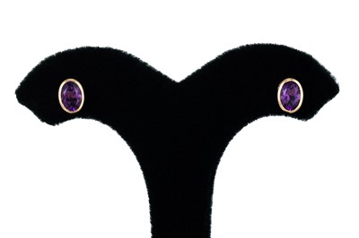 Lot 82 - A PAIR OF AMETHYST STUD EARRINGS, the oval...