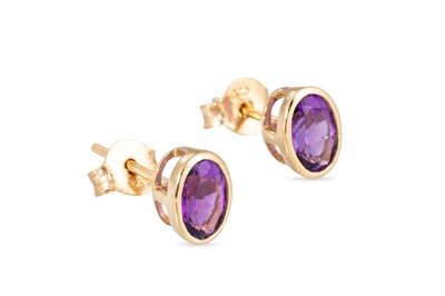 Lot 82 - A PAIR OF AMETHYST STUD EARRINGS, the oval...