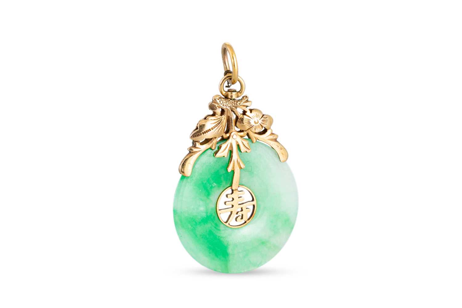 Lot 101 - A JADE PENDANT, mounted in 9ct yellow gold...