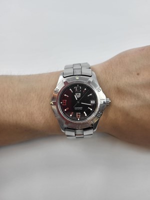 Lot 336 - A TAG HEUER AUTOMATIC WRIST WATCH, black dial...