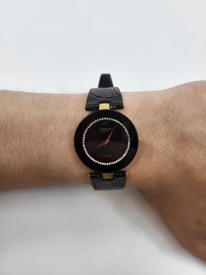 Lot 345 - A RAYMOND WEIL WRIST WATCH, black face with...