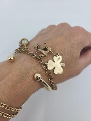 Lot 177 - A 9CT GOLD CHARM BRACELET, with padlock clasp,...
