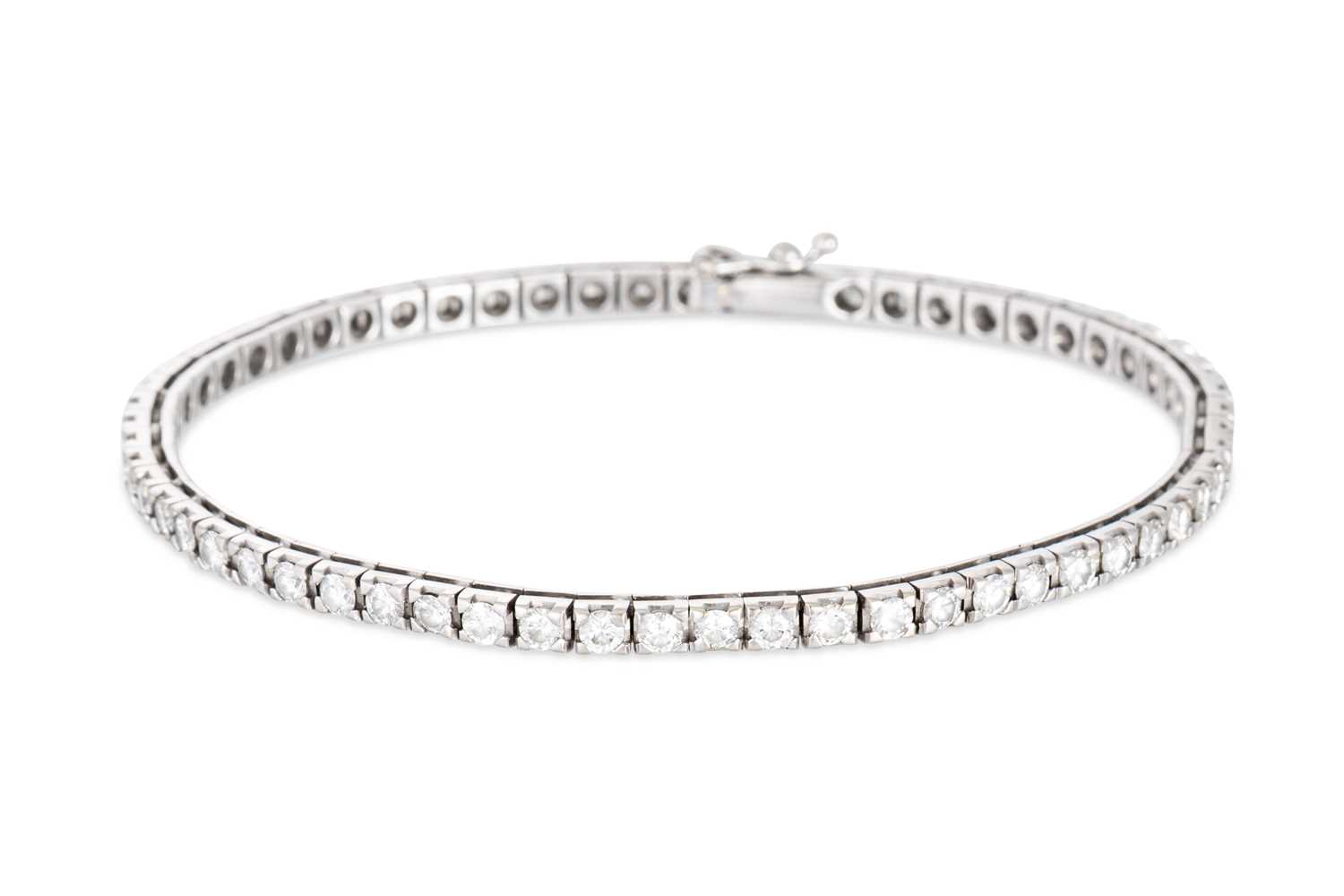 Lot 50 - A DIAMOND LINE BRACELET, the brilliant cut...