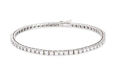Lot 50 - A DIAMOND LINE BRACELET, the brilliant cut...
