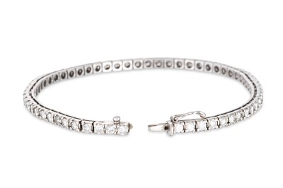 Lot 50 - A DIAMOND LINE BRACELET, the brilliant cut...