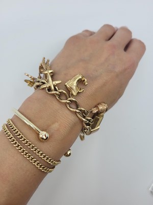 Lot 58 - A 9CT GOLD CURB LINK CHARM BRACELET,...