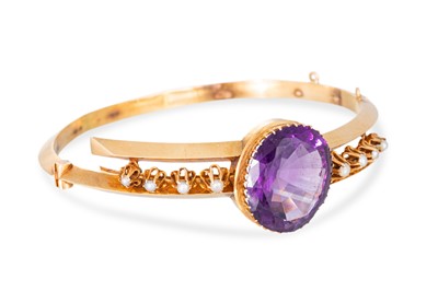 Lot 242 - A LATE VICTORIAN AMETHYST AND PEARL BANGLE, of...