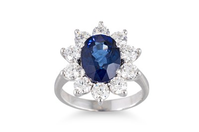 Lot 42 - A SAPPHIRE AND DIAMOND CLUSTER RING, the oval...