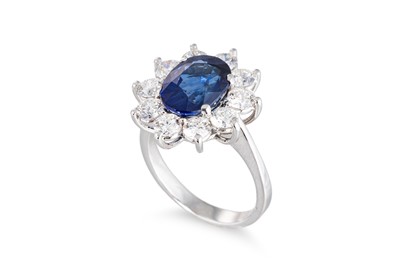 Lot 42 - A SAPPHIRE AND DIAMOND CLUSTER RING, the oval...