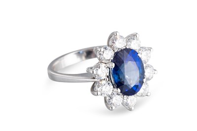 Lot 42 - A SAPPHIRE AND DIAMOND CLUSTER RING, the oval...