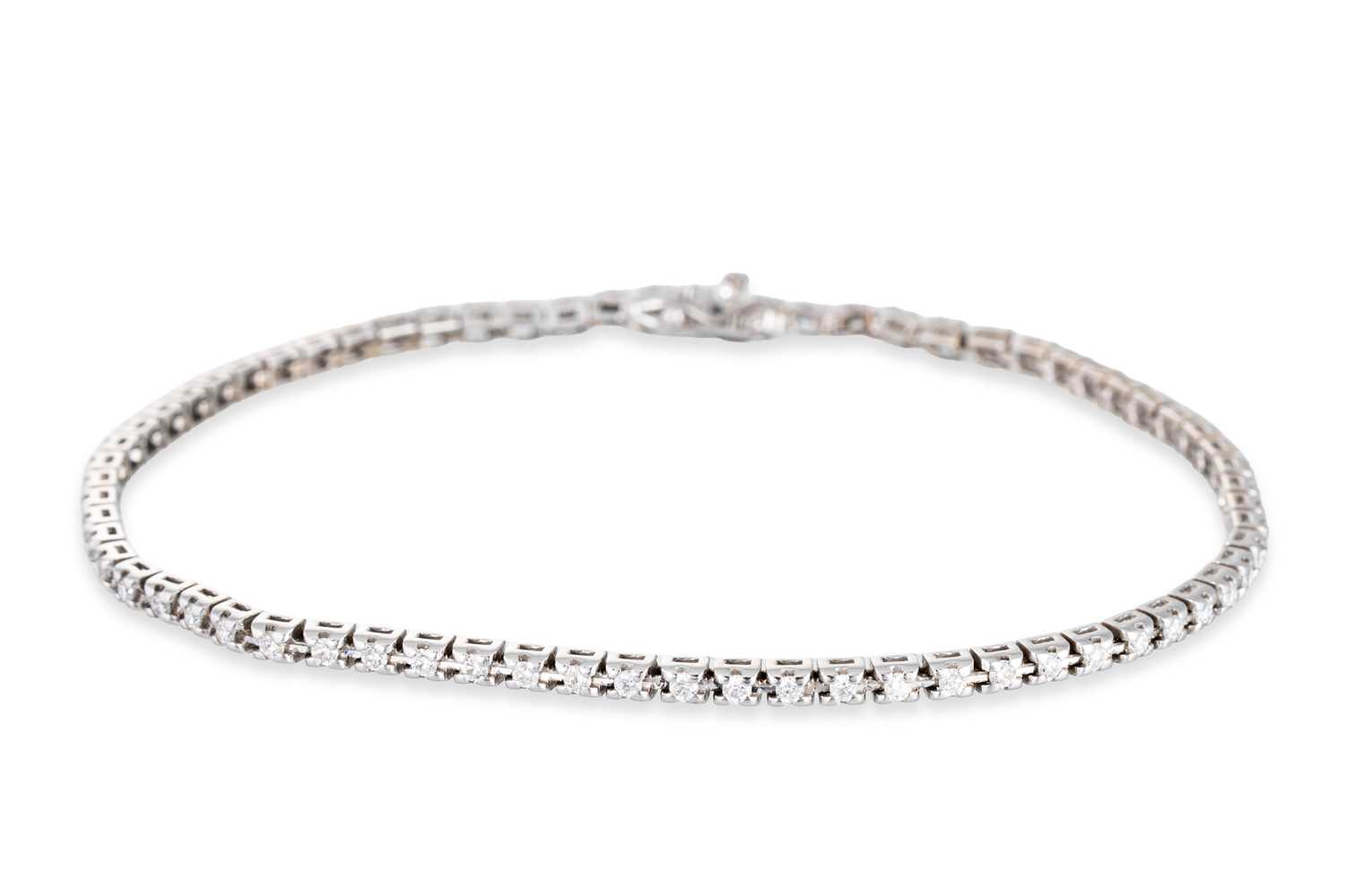 Lot 45 - A DIAMOND LINE BRACELET, the brilliant cut...