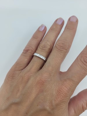 Lot 121 - A DIAMOND HALF ETERNITY RING, the ascher cut...