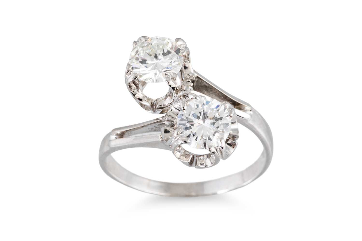 Lot 124 - A DIAMOND 'TOI ET MOI' CROSS-OVER RING, the...
