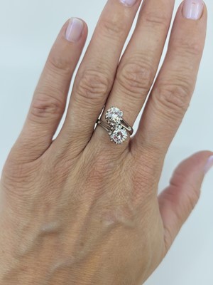 Lot 124 - A DIAMOND 'TOI ET MOI' CROSS-OVER RING, the...