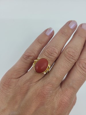 Lot 157 - A VINTAGE CORAL AND DIAMOND RING, the cabochon...
