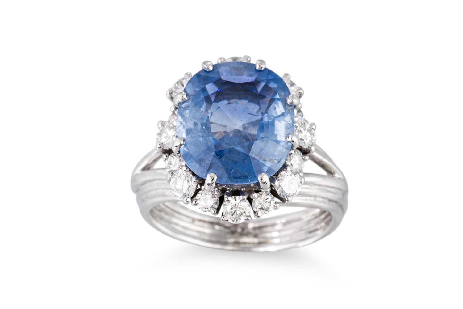 Lot 169 - A SAPPHIRE AND DIAMOND CLUSTER RING, mounted...