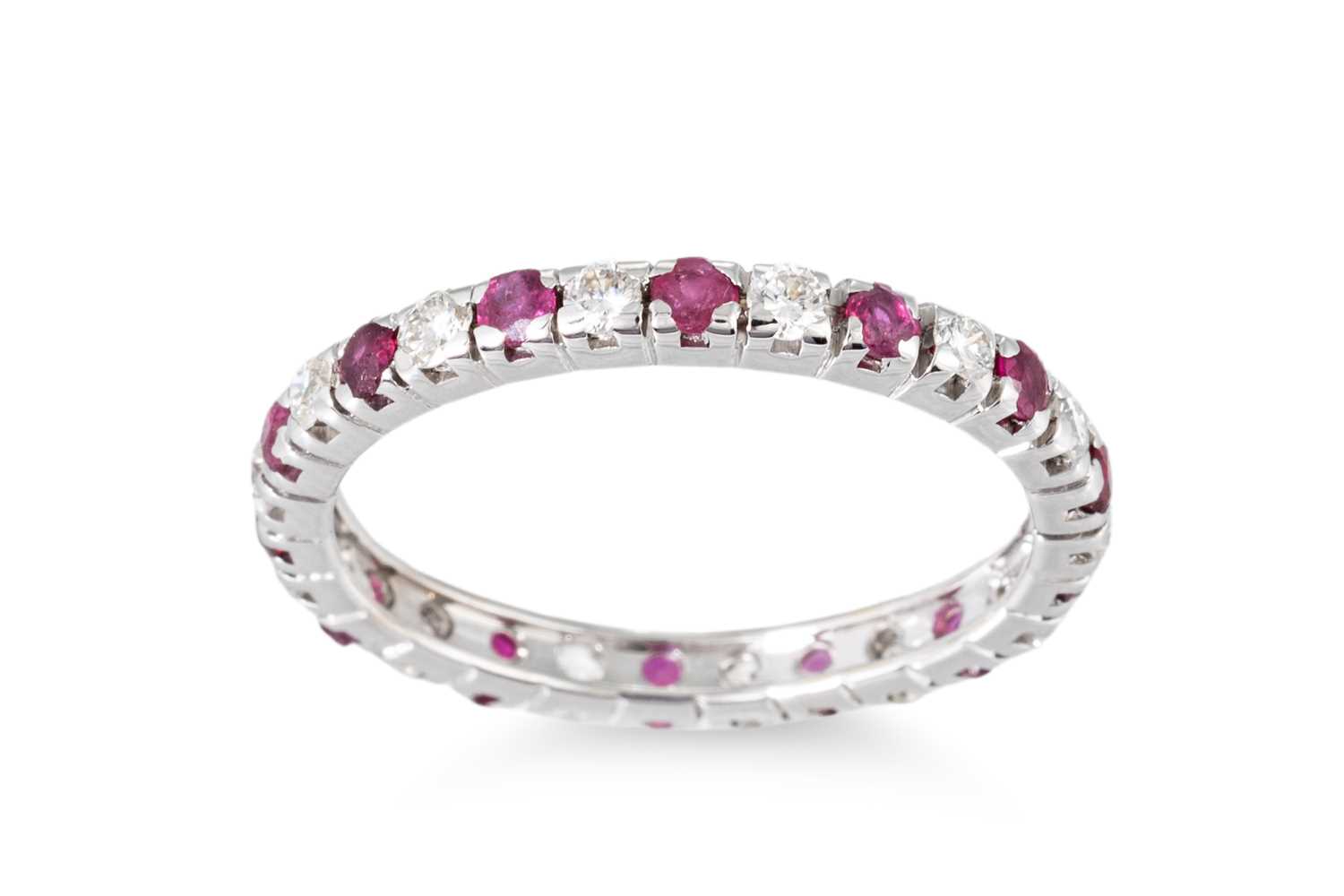 Lot 171 - A DIAMOND AND RUBY FULL ETERNITY RING, mounted...