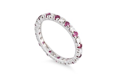Lot 171 - A DIAMOND AND RUBY FULL ETERNITY RING, mounted...